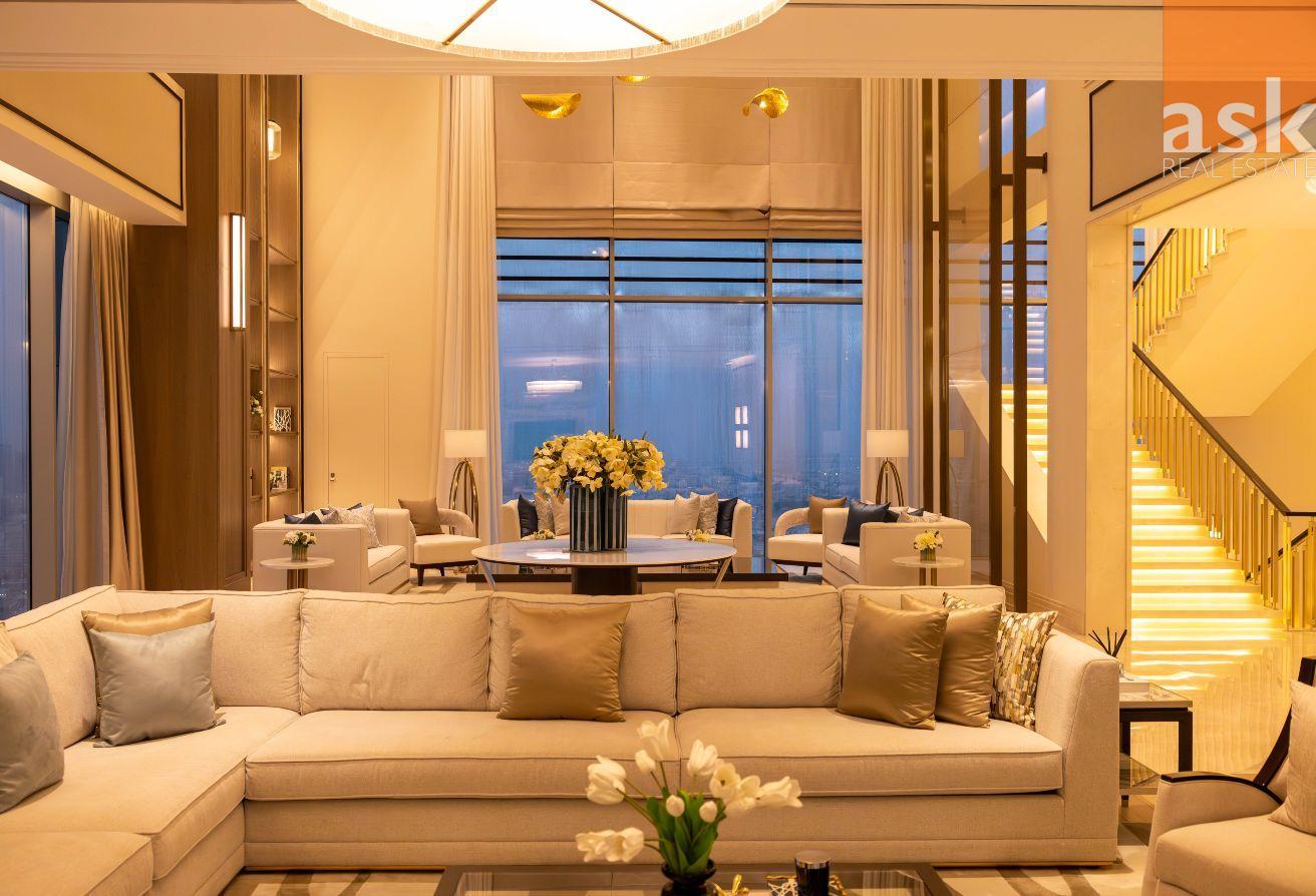 Double-height formal lounge with floor-to-ceiling glass